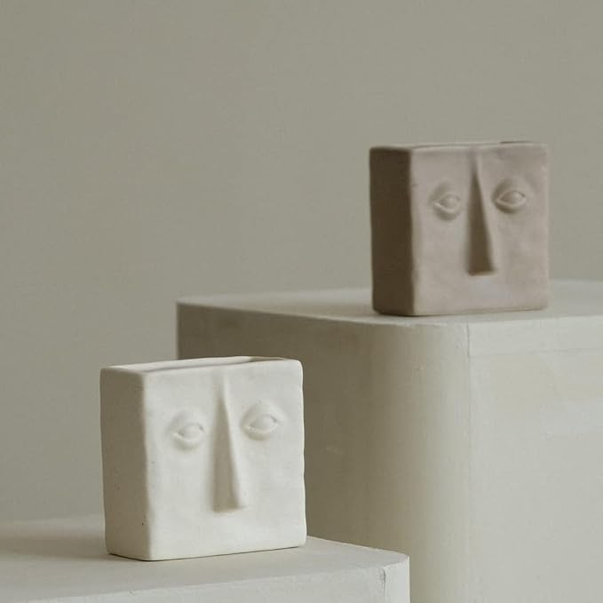 WENSHUO Ceramic Pen Holder, Pencil Holder for Desk, Desk Accessories, Crème | 3.7 in tall ceramic holder for pens, pencils, makeup brushes, or toothbrushes. Abstract face design displays small plants.
