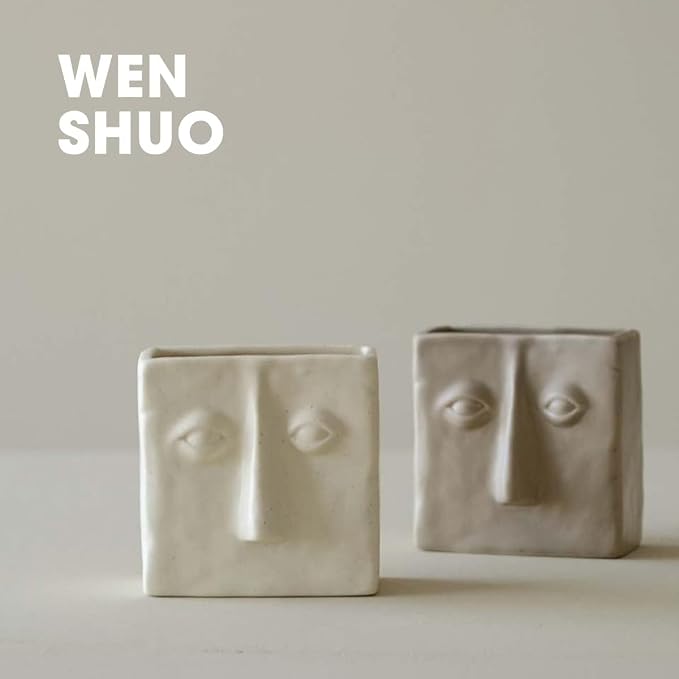 WENSHUO Ceramic Pen Holder, Pencil Holder for Desk, Desk Accessories, Crème | 3.7 in tall ceramic holder for pens, pencils, makeup brushes, or toothbrushes. Abstract face design displays small plants.